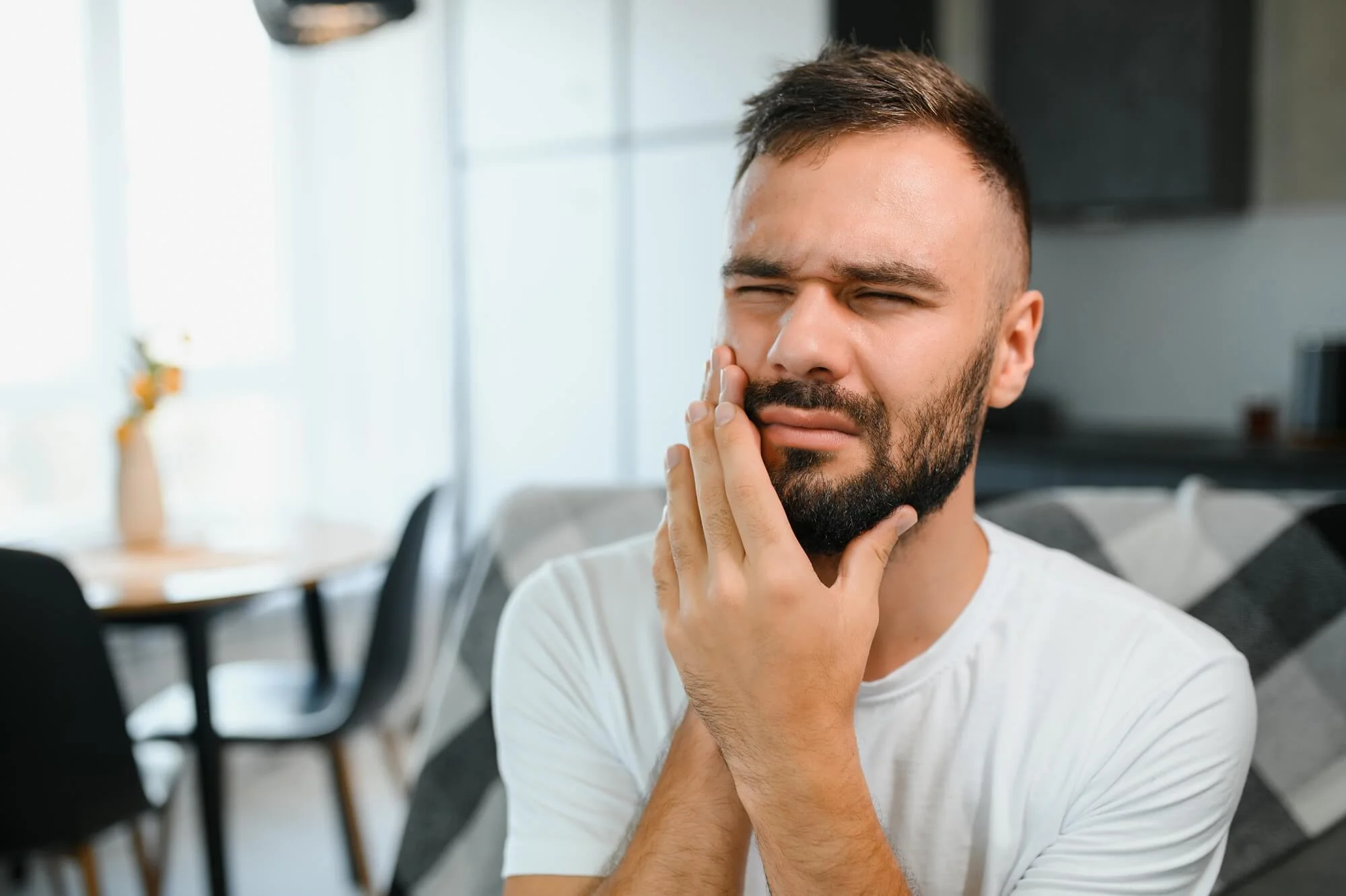 A young man suffering from toothache, in need of emergency dentist in Franklinville, NJ