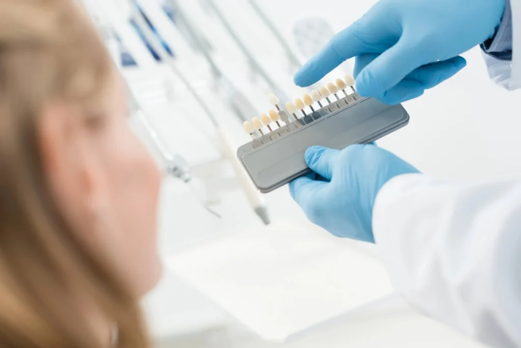 Dentist and female patient choosing the color of dental implants in Franklinville, NJ