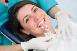 Dentist choosing shade for teeth whitening in Franklinville, NJ