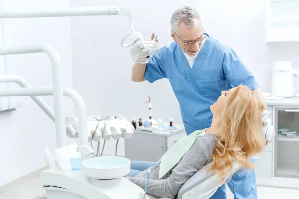 Dentist in Franklinville, NJ, consulting patient at a dental office.
