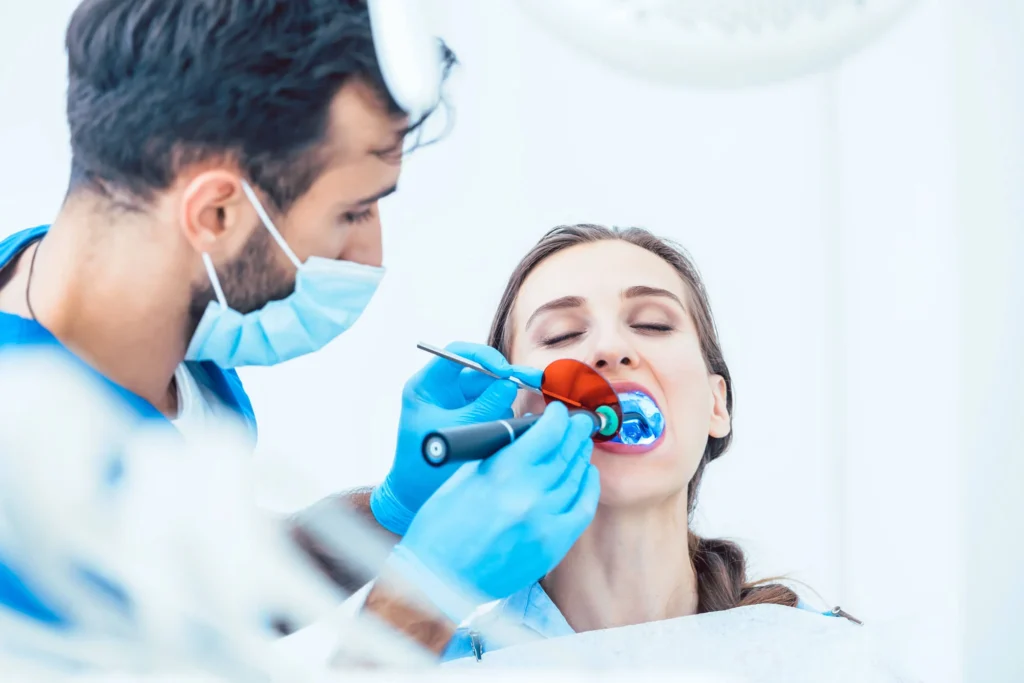 Dentist in Franklinville, NJ doing procedure on female patient