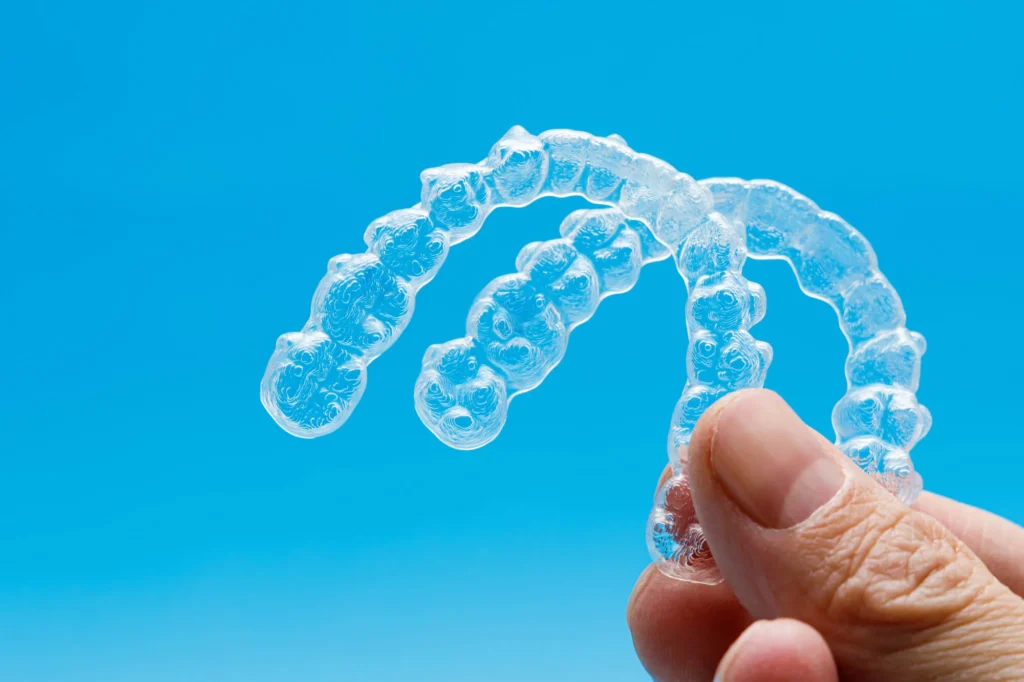 Invisalign on a blue background, as part of general dentistry in Franklinville, NJ