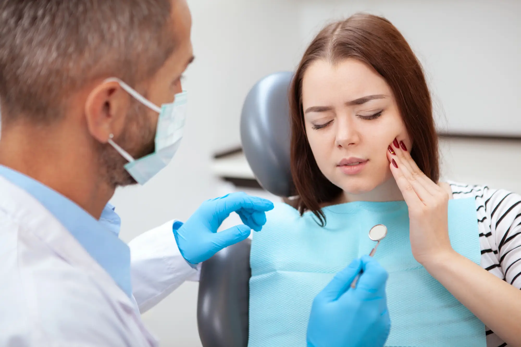 Patient with toothache visiting an Emergency Dentist Franklinville NJ.