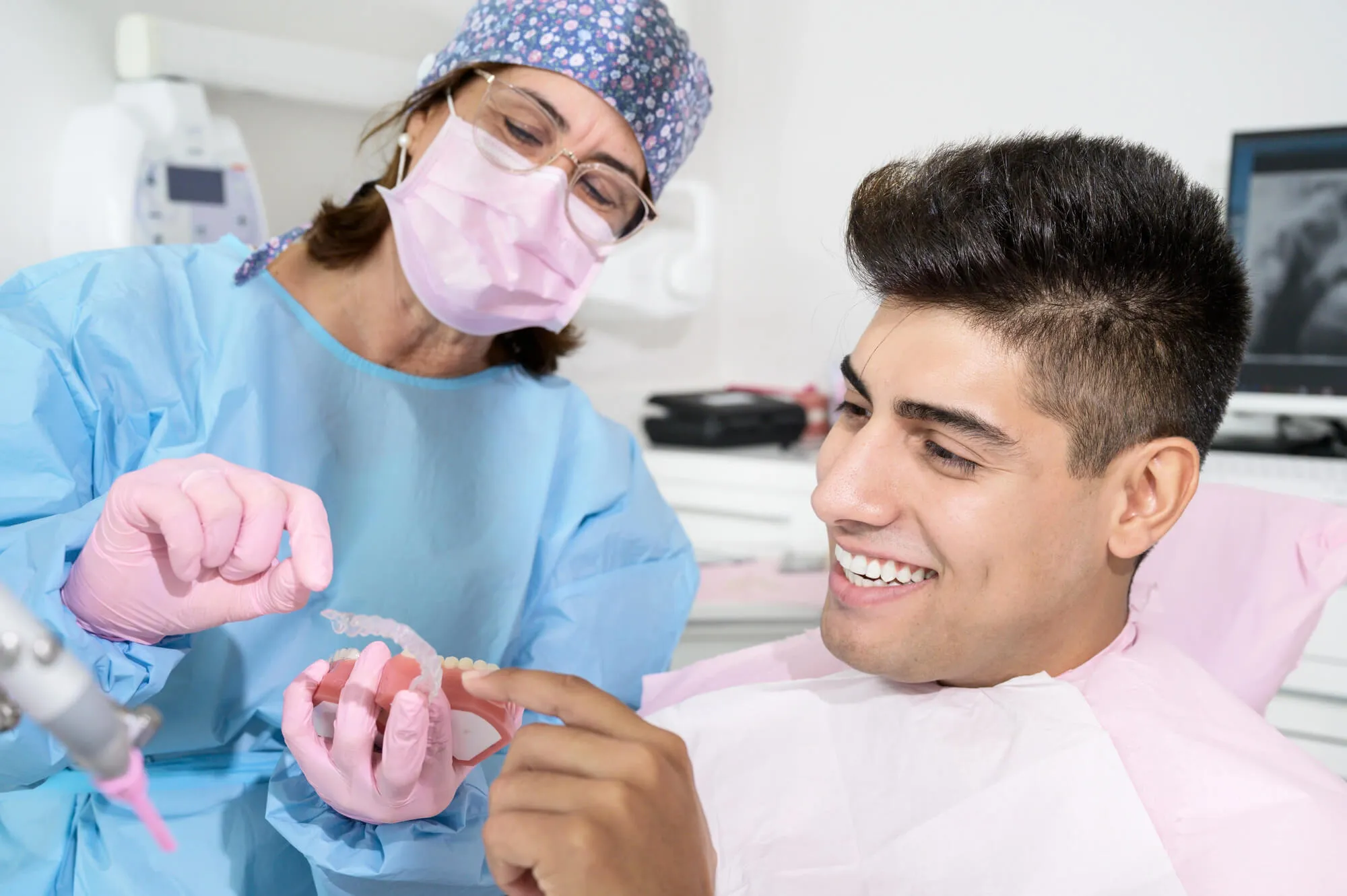 Dentist showing Invisalign options to a patient in Franklinville NJ